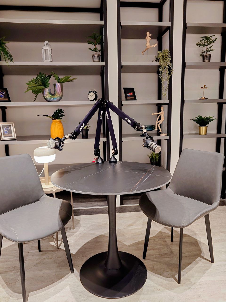 Podcast recording set with two chairs and Rode microphones